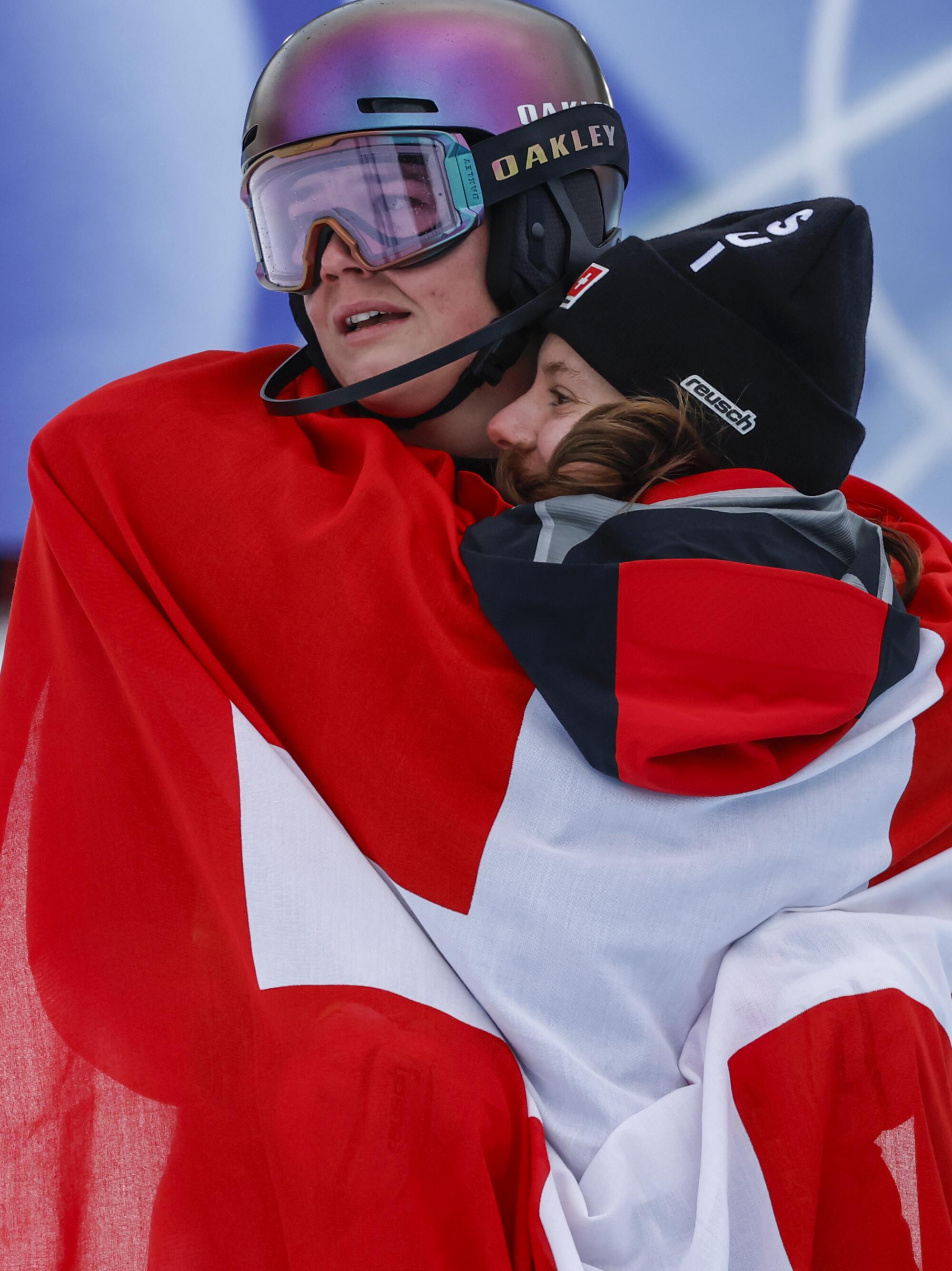 Swiss skier Melani Meillard weeps in the arms of her teammate Janine Schmitt.