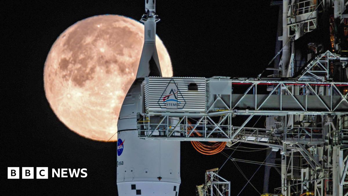 The Moon sets behind NASA's Artemis II SLS (Space Launch System) rocket and Orion spacecraft atop a mobile launcher at Launch Complex 39B at NASA's Kennedy Space Center in Florida on Sunday, February 1, 2026.