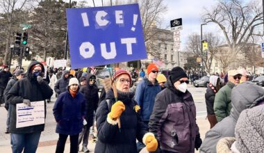 Ohio counselor Selena McKnight holds anti-ICE sign in photo with students