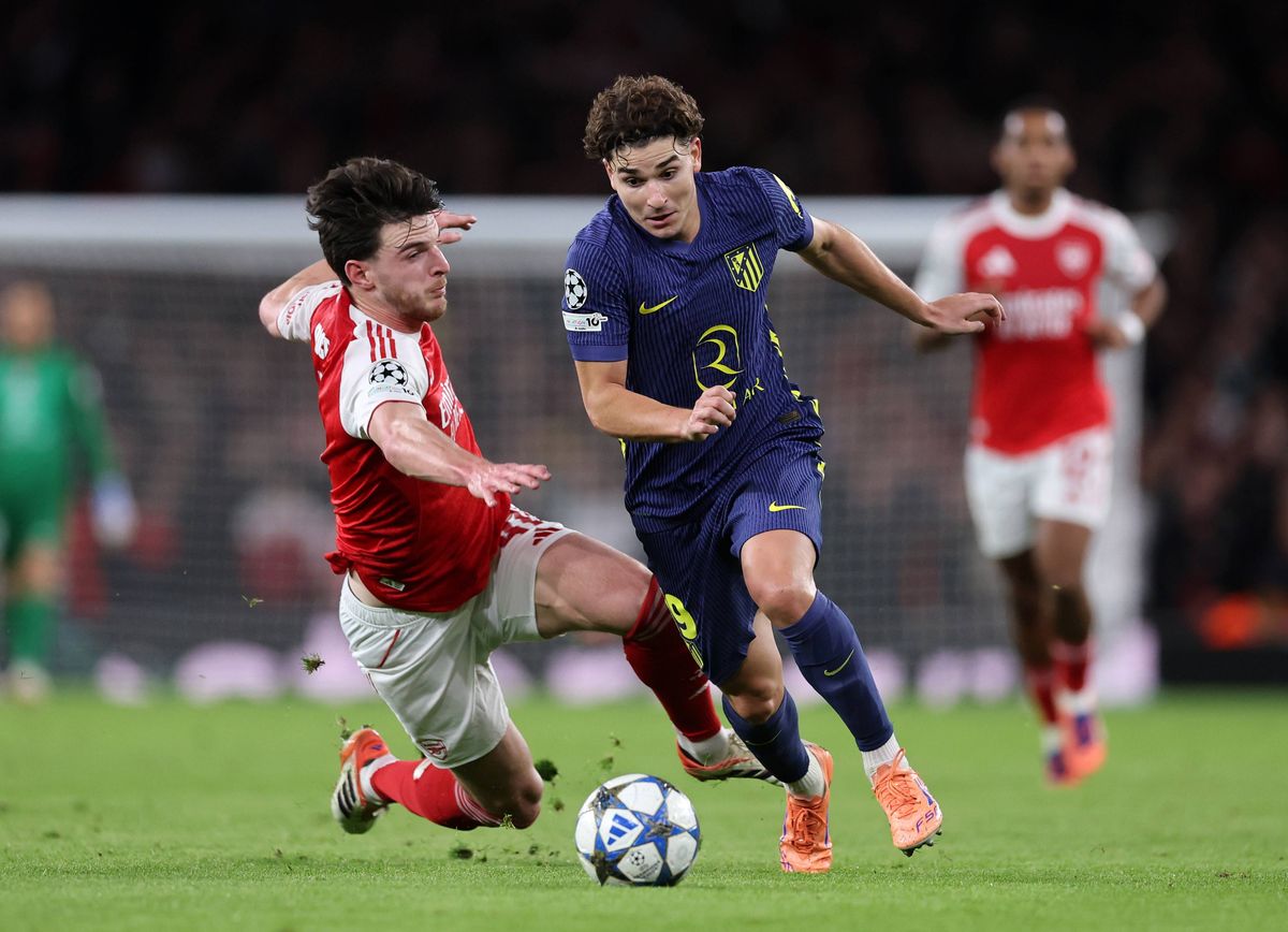 Declan Rice of Arsenal tackles Julian Alvarez of Atletico Madrid during the UEFA Champions League 2025/26 League Phase MD3 match between Arsenal FC and Atletico de Madrid