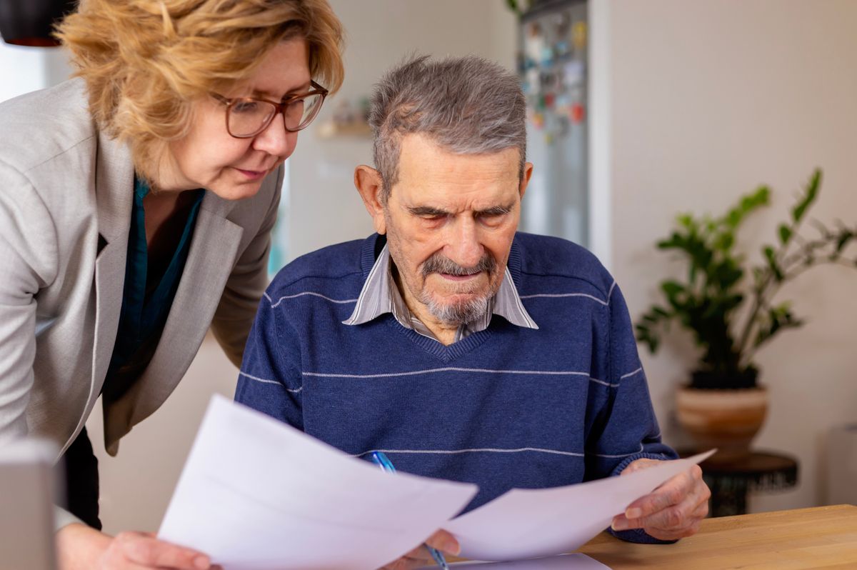 An older man looking at his financial documents