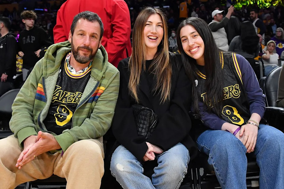 Adam Sandler, Jackie Sandler and Sadie Sandler attend an NBA basketball game on February 08, 2024 in Los Angeles, California. Allen Berezovsky/Getty