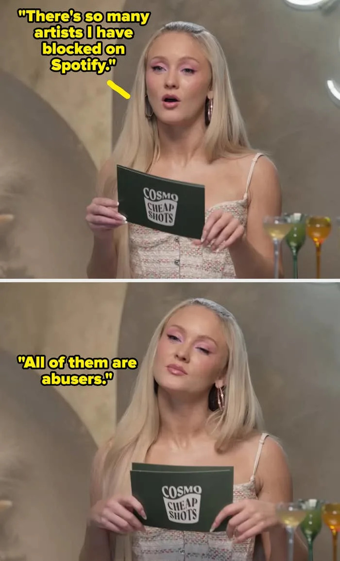 Zara Larsson with long hair, in a textured dress, holding a card with "Cosmo Cheap Shots" near cocktail glasses
