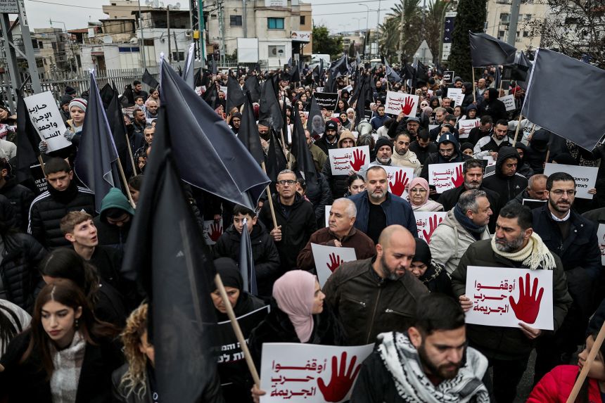 Members of Israel's Arab minority protest, calling on the Israeli government to tackle a wave of crime and killings from within Arab communities through effective law and order, in Sakhnin,  Israel, on January 22.