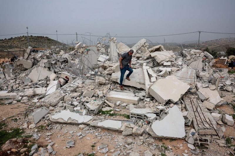 A Palestinian man stands amid the rubble of a building demolished by Israeli military, in the town of Shuqba near Ramallah in the Israeli-occupied West Bank, February 9, 2026.