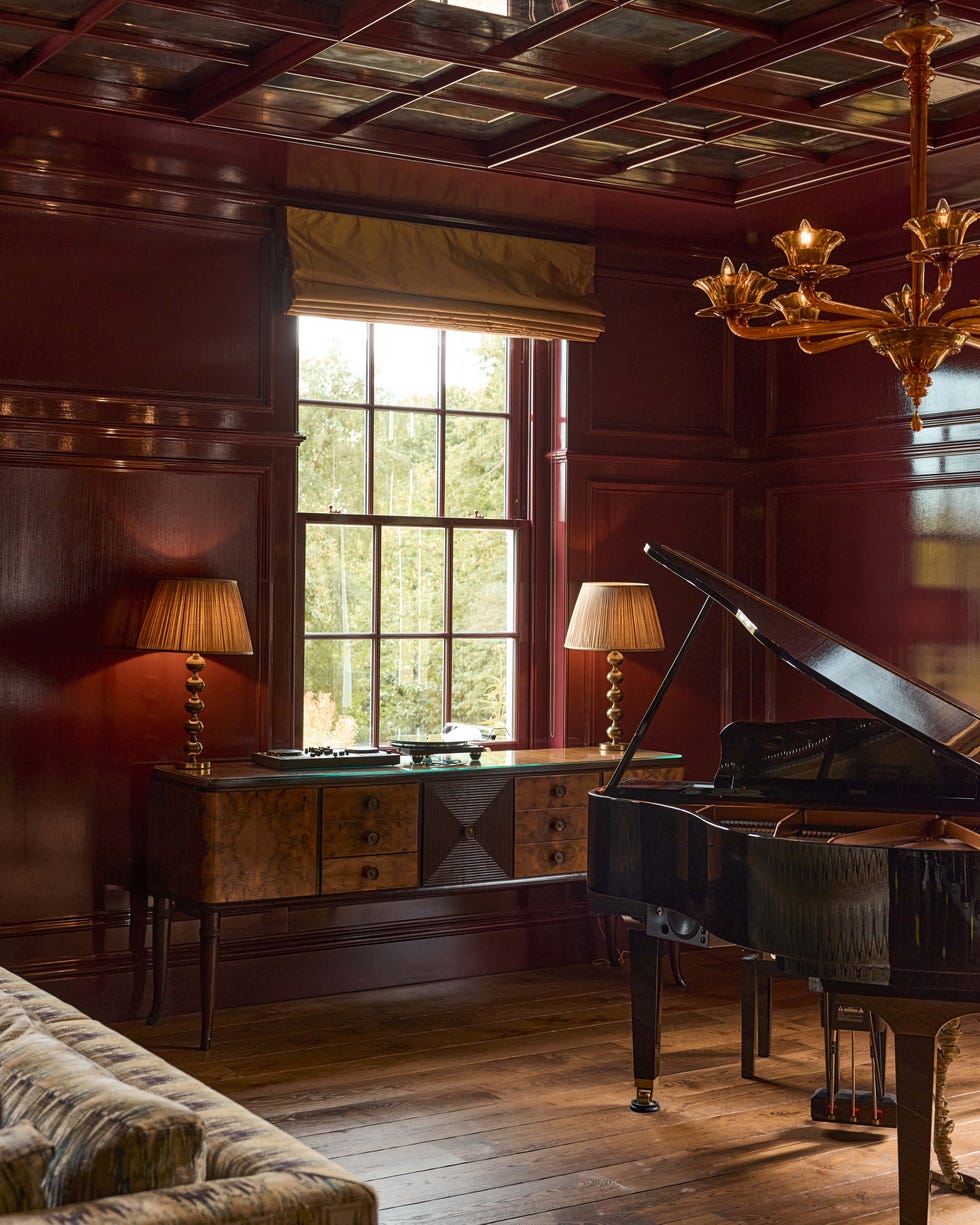 Elegant room featuring a grand piano and stylish furniture.