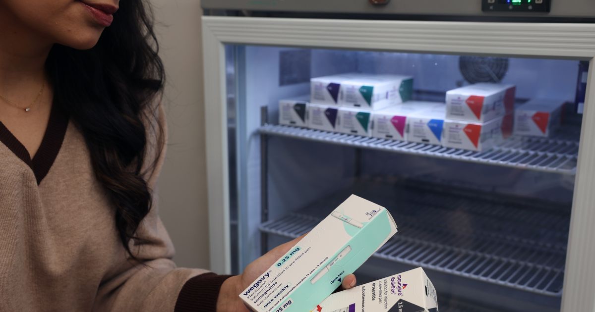 A woman uses a Mounjaro injection pen on October 4, 2025 in Cardiff, Wales.