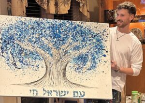 Israeli artist and combat soldier Albert Levi with his artwork.