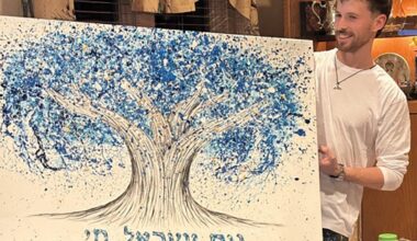 Israeli artist and combat soldier Albert Levi with his artwork.