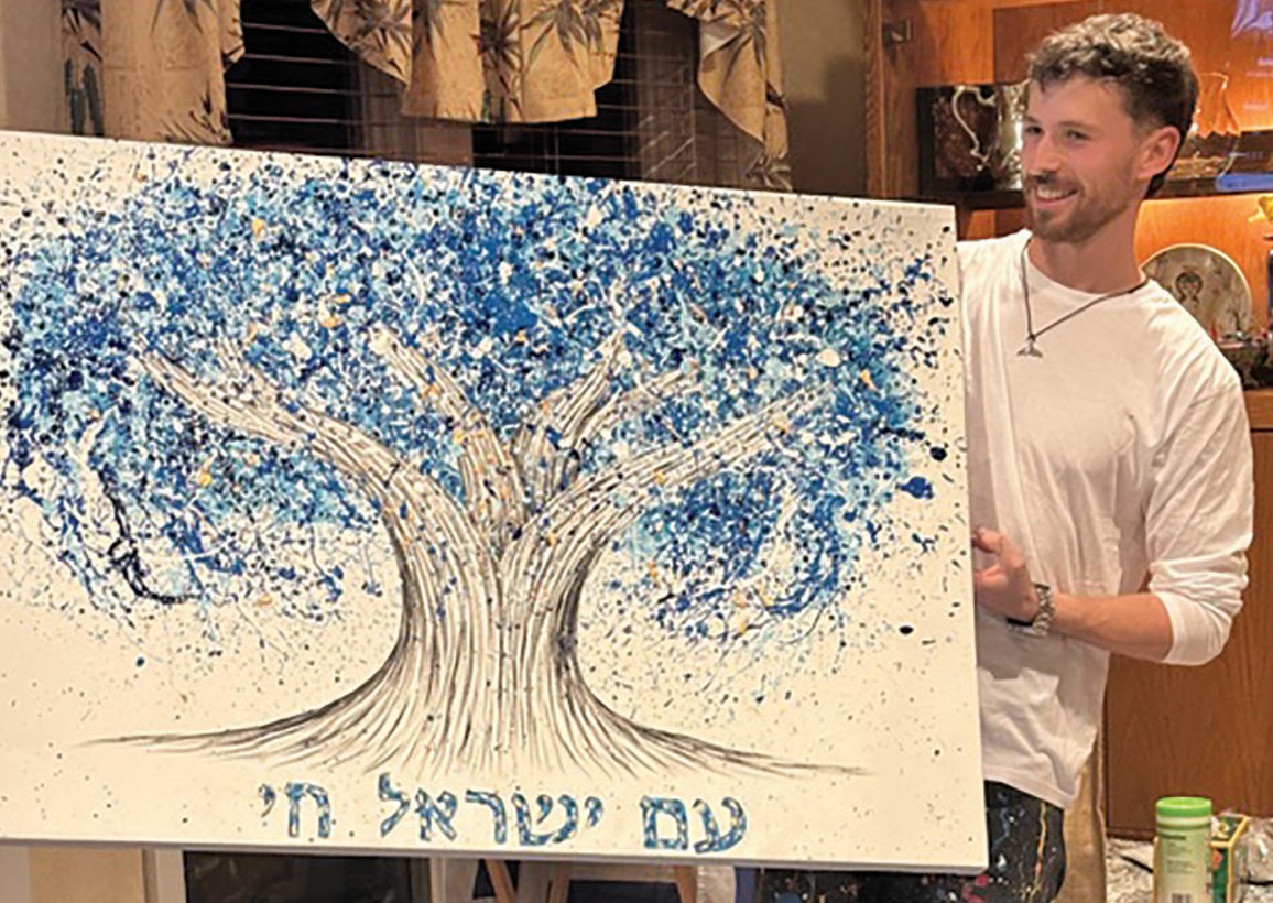 Israeli artist and combat soldier Albert Levi with his artwork.