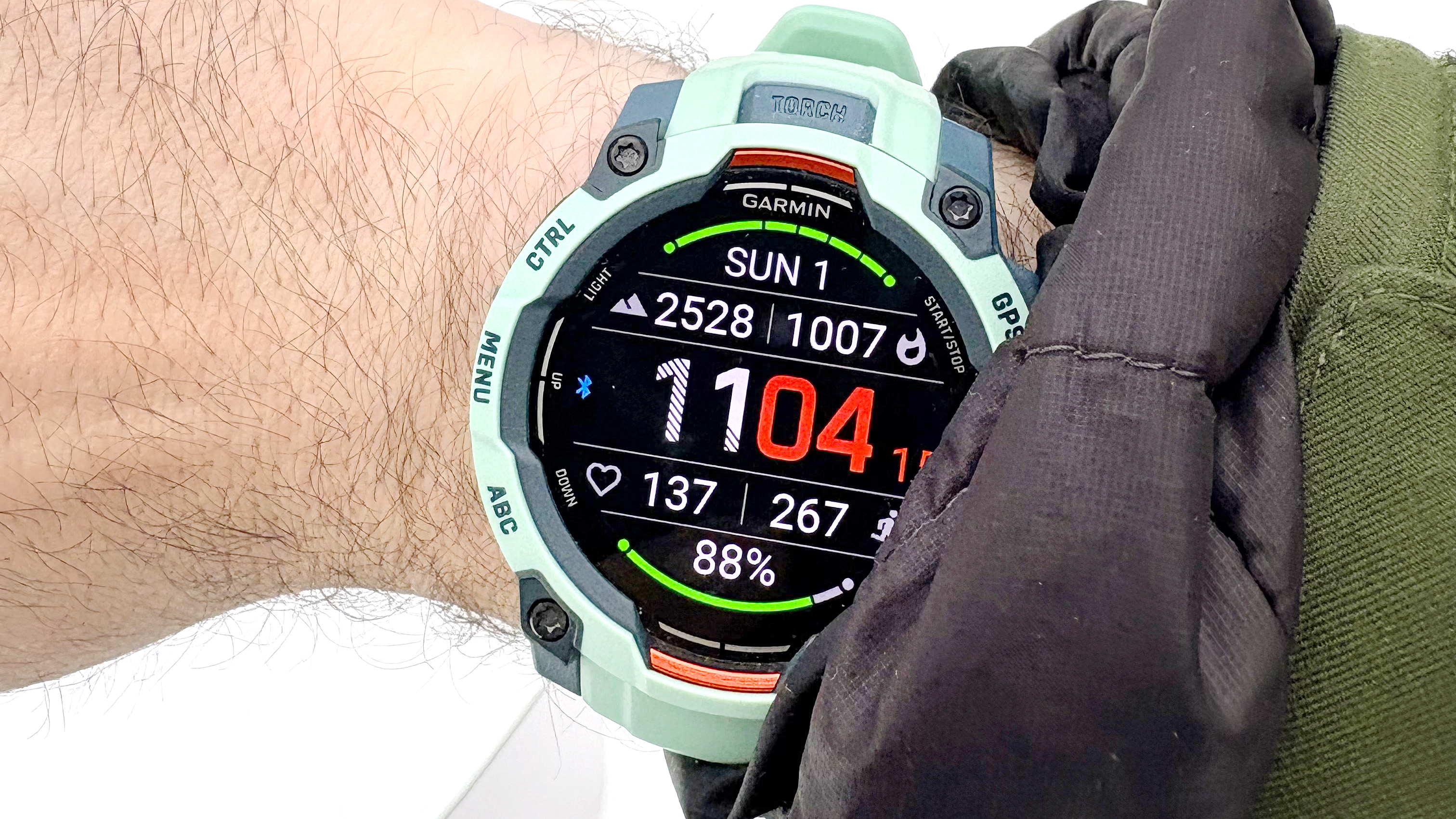 Garmin Instinct 3 on a user's wrist in the snow