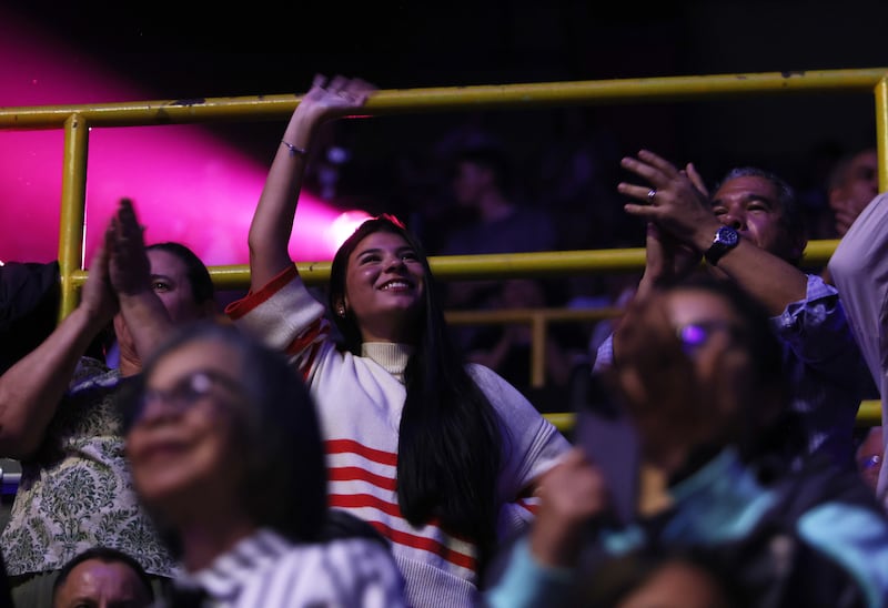 Livia Domingos waves and cheers following a song by Nathan Pacheco during the "Songs of Hope" tour concert by The Tabernacle Choir and Orchestra at Temple Square at Ginasio do Ibirapuera in São Paulo, Brazil, Friday, Feb. 27, 2026.