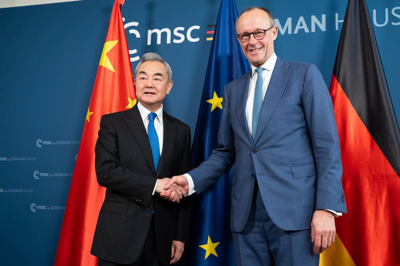 Chinese foreign minister Wang Yi shakes hands with German chancellor Friedrich Merz. Photograph: Michael Bihlmayer/Pool/Getty Images