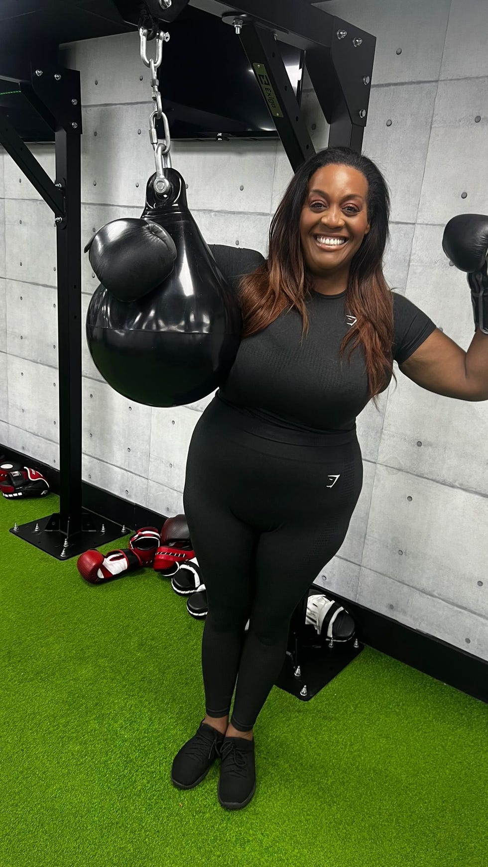 person interacting with a boxing bag in a gym