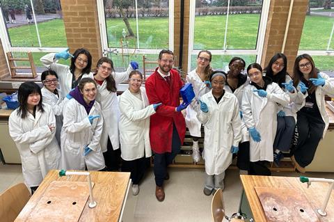 School students with tutor and large crystal