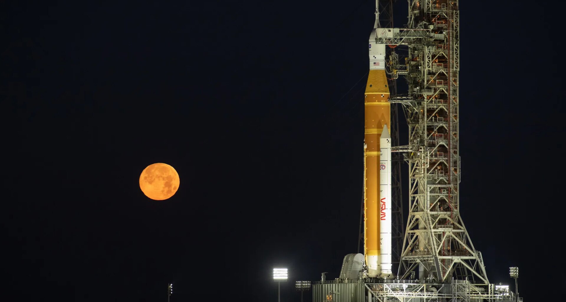 The Moon rises behind NASA’s Artemis II SLS (Space Launch System) rocket and Orion spacecraft atop a mobile launcher at Launch Complex 39B at NASA’s Kennedy Space Center in Florida on Sunday, Feb. 1,. 2026. The Artemis II test flight will take Commander Reid Wiseman, Pilot Victor Glover, and Mission Specialist Christina Koch from NASA, and Mission Specialist Jeremy Hansen from the CSA (Canadian Space Agency), around the Moon and back to Earth.