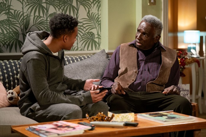 550940,TITLE:Eastenders Patrick looks shocked as Denzel shows him a mobile phone in a scene from EastEnders.