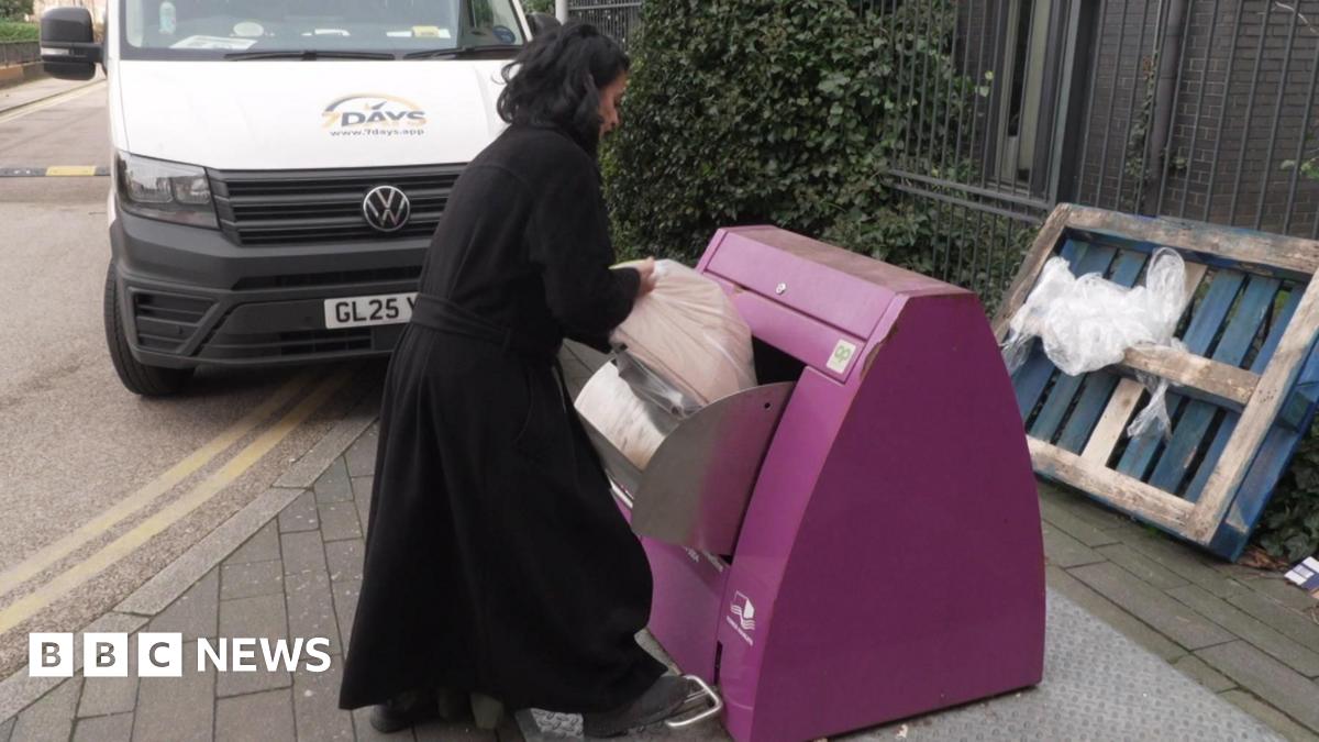 An older lady with long grey hair talks to another woman outside some flats in east London