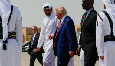 US President Donald Trump is escorted by Qatar's Emir Tamim bin Hamad Al Thani towards Air Force One, as he departs Al Udeid Air Base, en-route to Abu Dhabi, United Arab Emirates, in Doha, Qatar, May 15, 2025.