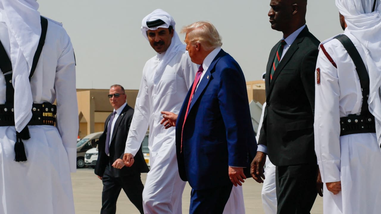 US President Donald Trump is escorted by Qatar's Emir Tamim bin Hamad Al Thani towards Air Force One, as he departs Al Udeid Air Base, en-route to Abu Dhabi, United Arab Emirates, in Doha, Qatar, May 15, 2025.