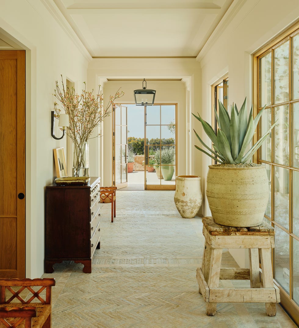 Interior hallway with natural light and decorative elements.