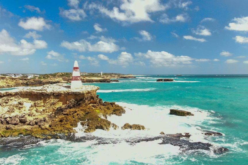 The Robe obelisk on rocky land with the ocean to the right