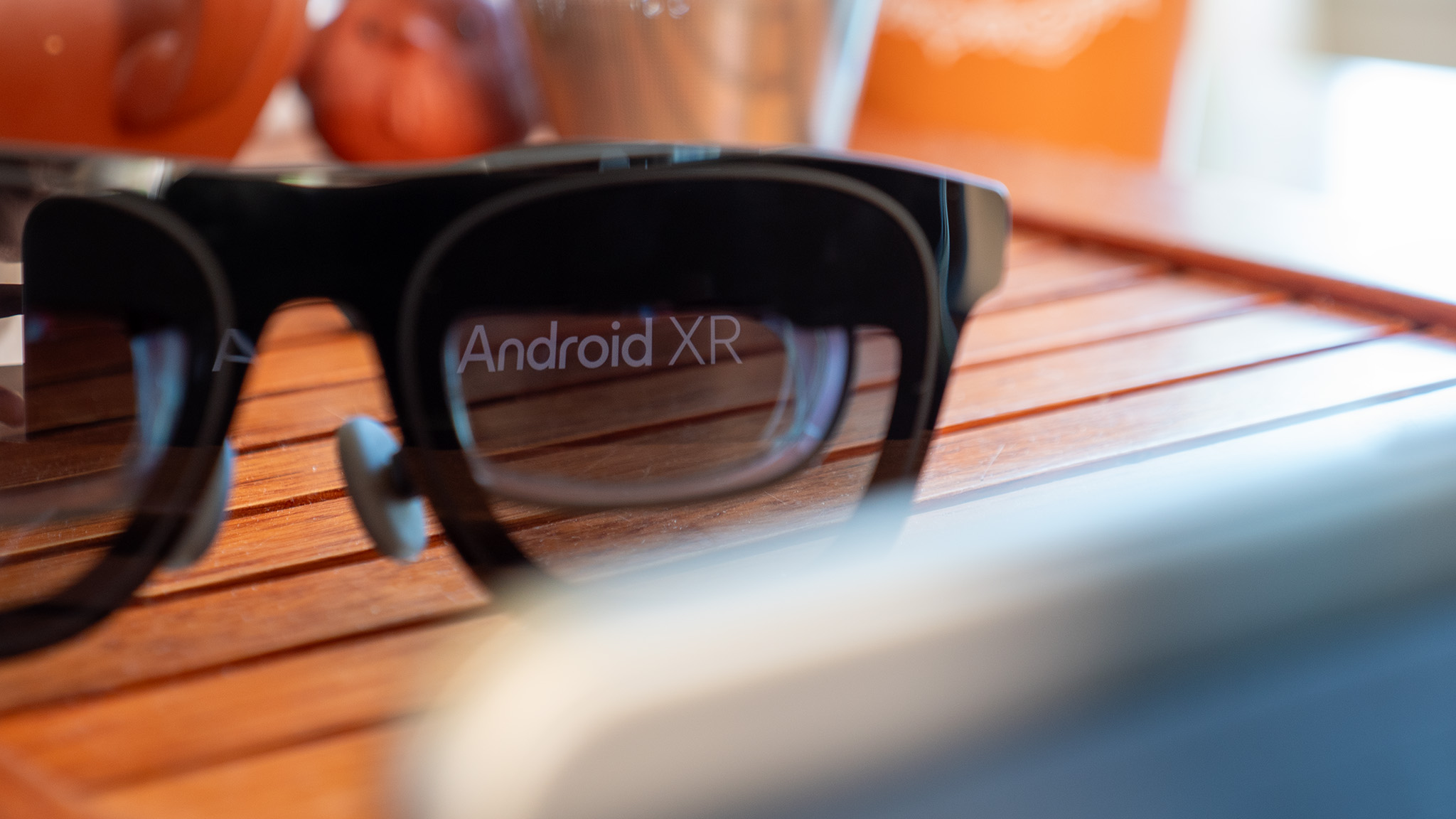 The Android XR logo reflected in the left lens of a pair of Xreal One smart glasses