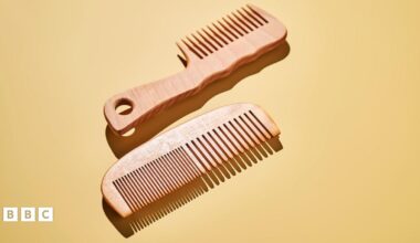 Two wooden combs on a yellow background
