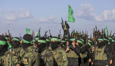 Palestinian militant group Hamas fighters secure an area before handing over an Israeli-American hostage to a Red Cross team in Gaza City on February 1, 2025, as part of the fourth hostage-prisoner exchange. Ranks of Hamas fighters formed up on Gaza's beachfront on February 1 for the handover of an Israeli-American hostage Keith Siegel in a show of force against the dramatic backdrop of breaking waves. (Photo by Saeed Jaras / Middle East Images via AFP)