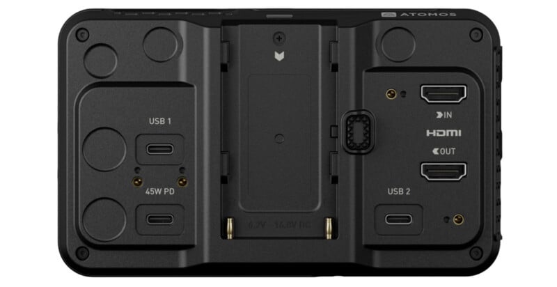 Back view of a black Atomos device showing various ports, including two USB-C ports, two HDMI ports labeled IN and OUT, a DC power port, and a central battery slot. The ports are labeled for easy identification.
