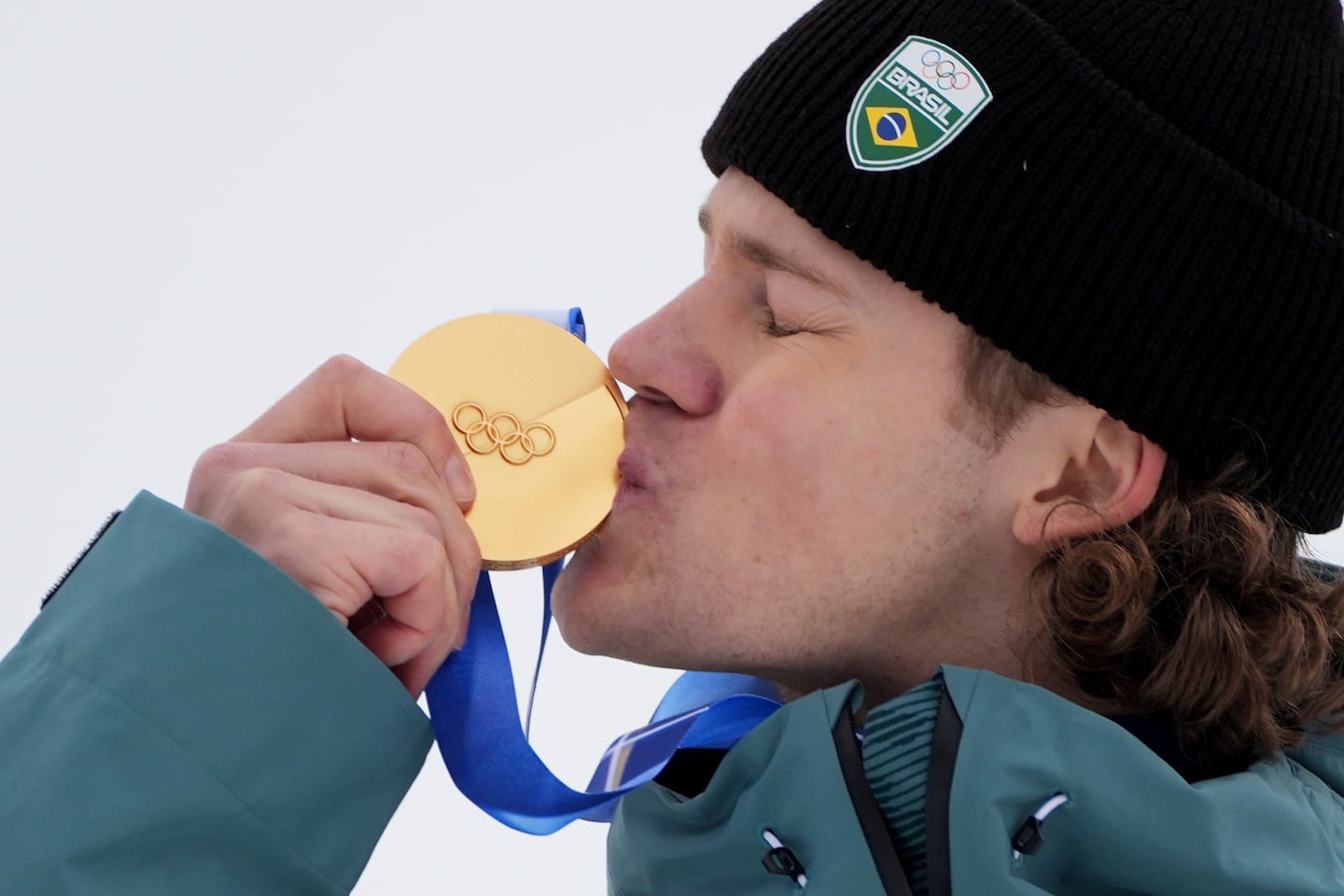 It was a kiss decades in the making, as Brazil's Lucas Pinheiro Braathen smooches his gold medal after winning Saturday's giant slalom in Bormio, Italy, for South America's first medal at a Winter Olympics.