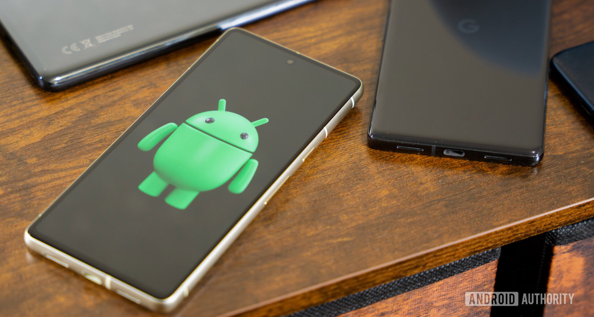 Android robot on smartphone next to other devices and accessories (4)