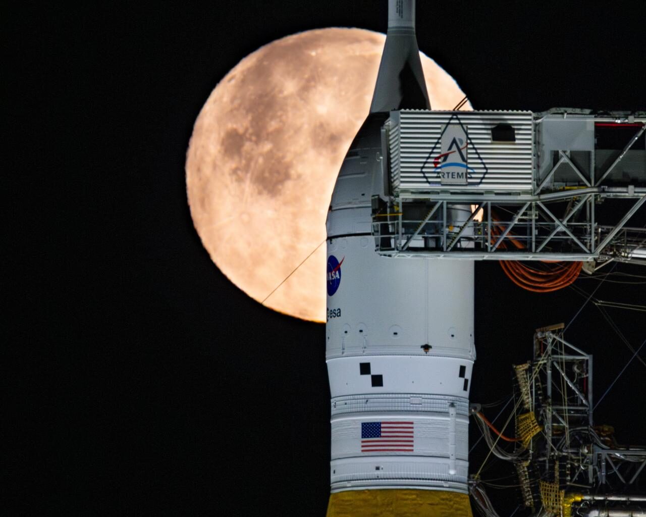A full Moon is seen shining over NASA’s SLS (Space Launch System) and Orion spacecraft, atop the mobile launcher in the early hours of February 1, 2026. The rocket is currently at Launch Pad 39B at NASA’s Kennedy Space Center in Florida, as teams are preparing for a wet dress rehearsal to practice timelines and procedures for the launch of Artemis II.