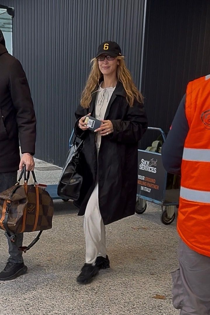 Image may contain Soledad Solaro Clothing Coat Adult Person Pedestrian Accessories Bag Handbag and Baseball Cap