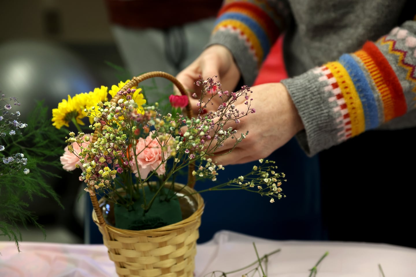 Colleen builds her bouquet of flowers at the  Acton Garden Club Flower Day at Emerson Hospital.