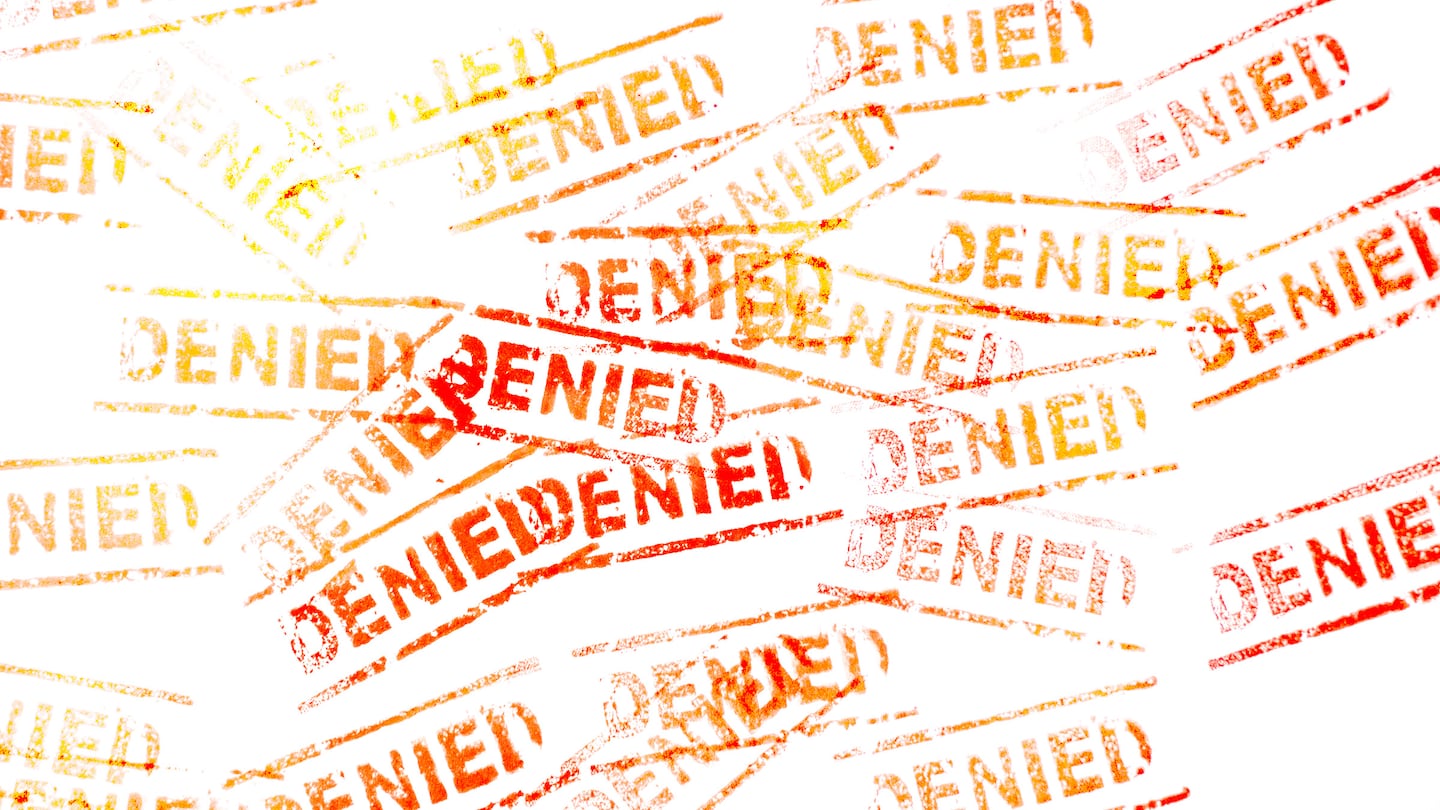 Stamp of the word "denied" repeated many times in yellow and red