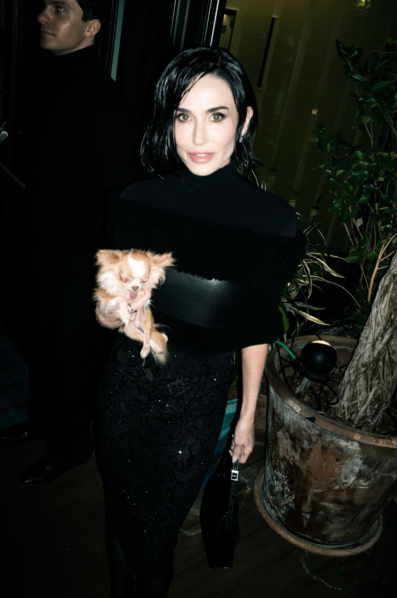 Image may contain Demi Moore Black Hair Hair Person Adult Photobombing Face Head Clothing Footwear and Shoe