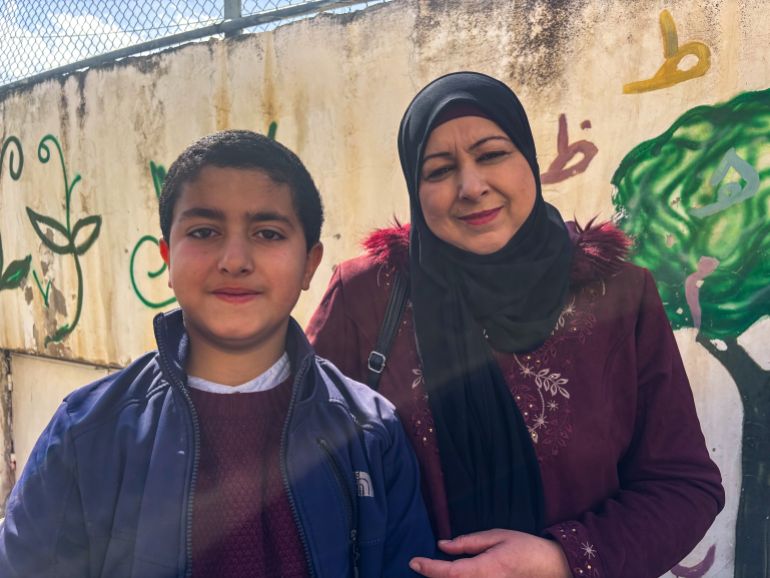 Eman Hassaneh and her 10-year-old son, Zaid [Al Jazeera]