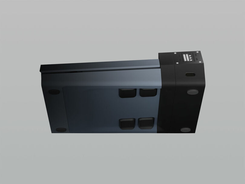 A rectangular black and gray electronic device with buttons and a USB port on one end, viewed from an angled side perspective.