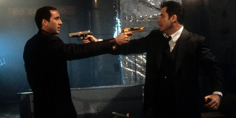 John Travolta and Nicolas Cage as Castor and Sean aiming guns at each other in Face/Off.