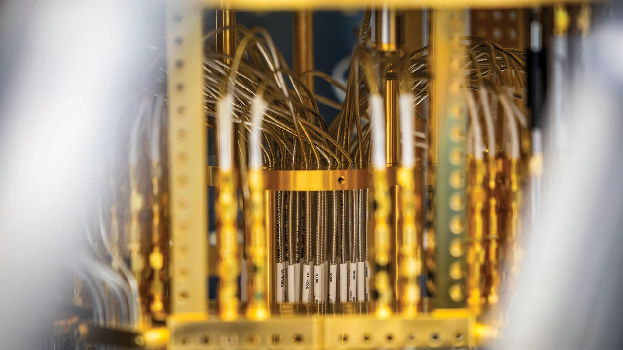Gold colored device with bundles of thin wires and metallic components arranged vertically.