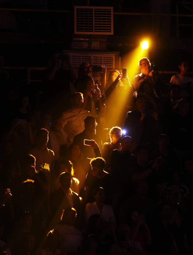 Audience members stand and are illuminated by yellow spot lights during the “Hallelujah” from Handel’s Messiah  during the Songs of Hope Tour by The Tabernacle Choir and Orchestra at Temple Square at Ginasio do Ibirapuera in São Paulo, Brazil, Friday, Feb. 27, 2026.