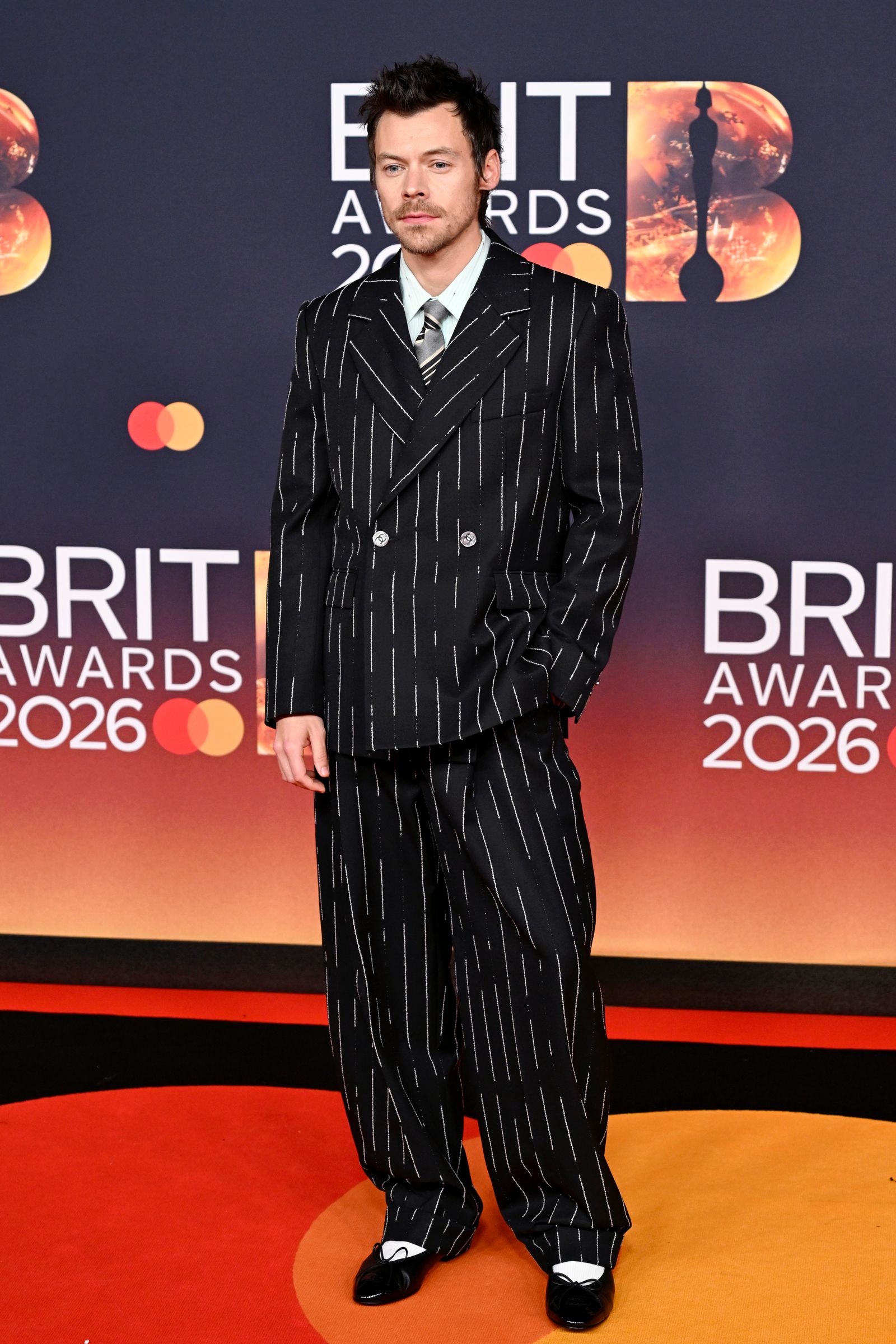 Image may contain Harry Styles Clothing Formal Wear Suit Fashion Adult Person Coat and Pajamas