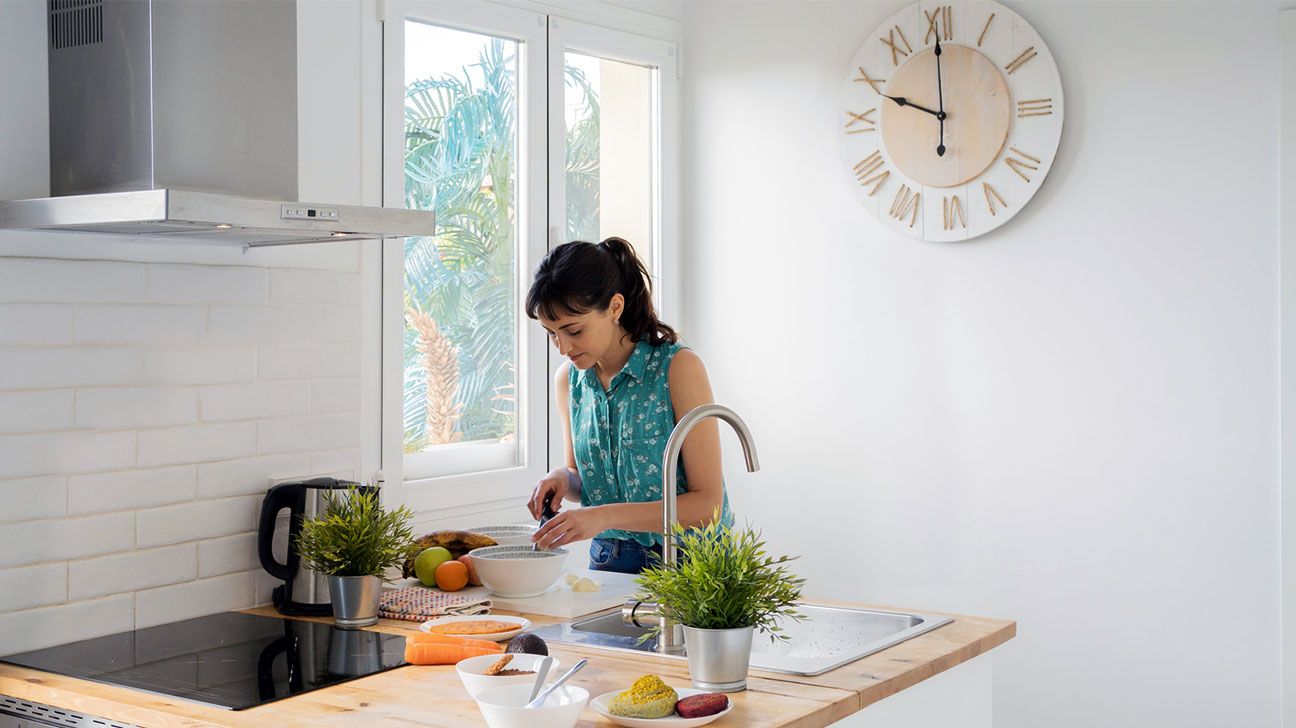Female preparing meals in kitchen