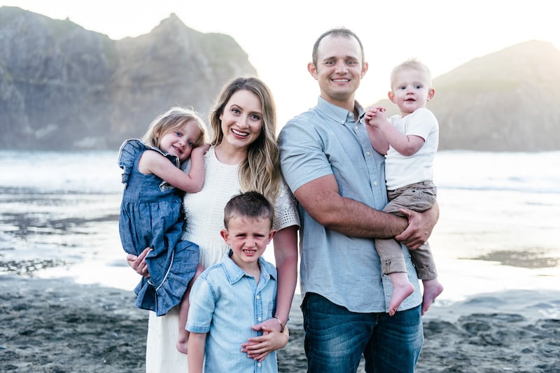 Angie Killian, composer of "Anytime, anywhere," poses with her family for a photo on Gold Beach in Oregon in 2019, the year "Anytime, anywhere" was written.