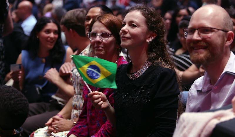 Ala La Mar waves a Brazilian flag as she waits with her family during the Songs of Hope Tour by The Tabernacle Choir and Orchestra at Temple Square at Ginasio do Ibirapuera in São Paulo Brazil, Friday, February 27, 2026.