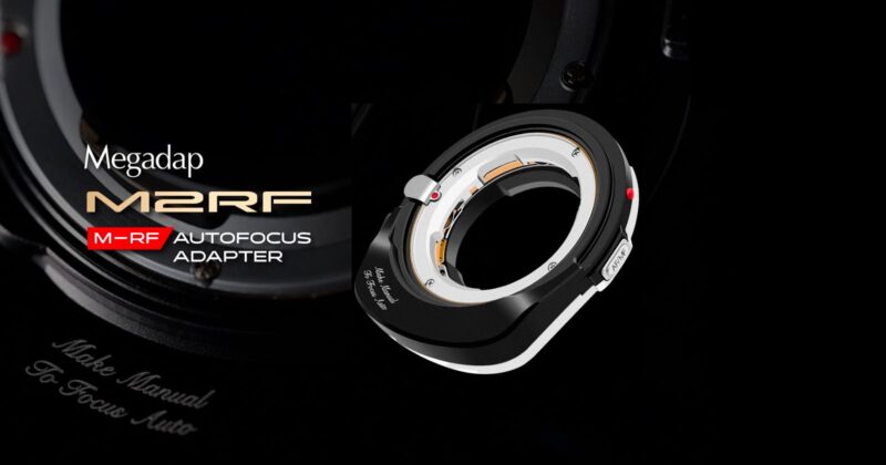 A black and silver Megadap M2RF autofocus adapter is displayed prominently on a dark background, with the product name and logo in bold white and gold text beside it.