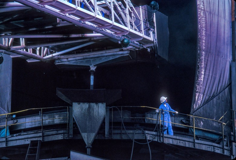  A Detroit Edison worker guides the unloading boom of the freighter "Walter J. McCarthy, Jr." to a coal chute at the St. Clair, MI plant. 