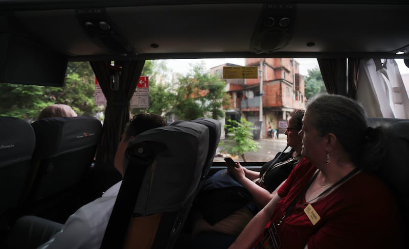 Tabernacle Choir at Temple Square members look out the window at the street of São Paulo, Brazil, as they travel to the concert prior to their performance in the "Songs of Hope" tour concert by The Tabernacle Choir and Orchestra at Temple Square at Ginasio do Ibirapuera in São Paulo, Brazil, Friday, Feb. 27, 2026.