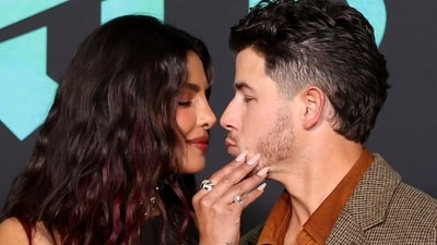 Priyanka Chopra and Nick Jonas share a romantic moment on the red carpet at The Bluff premiere.